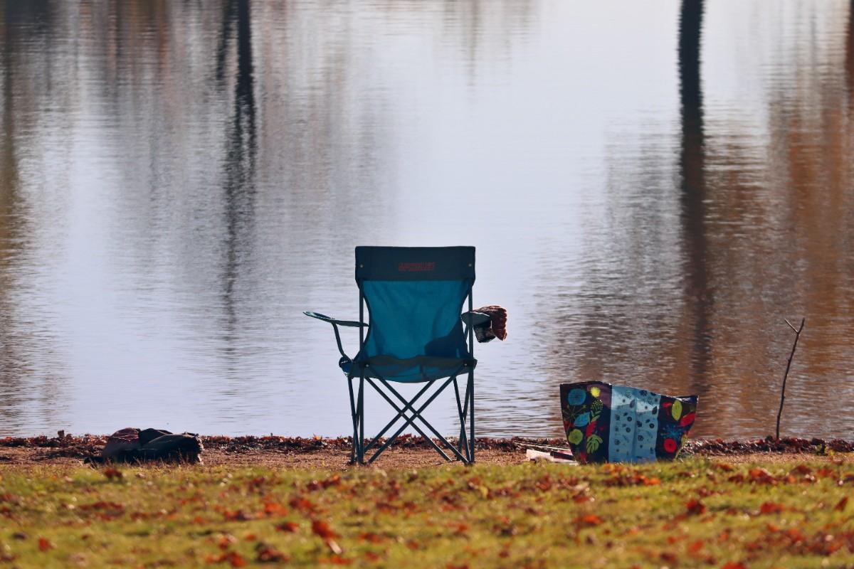 Fishing chair set up by a calm lake